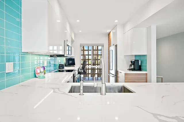 a bedroom with a bed flat screen tv and a large window