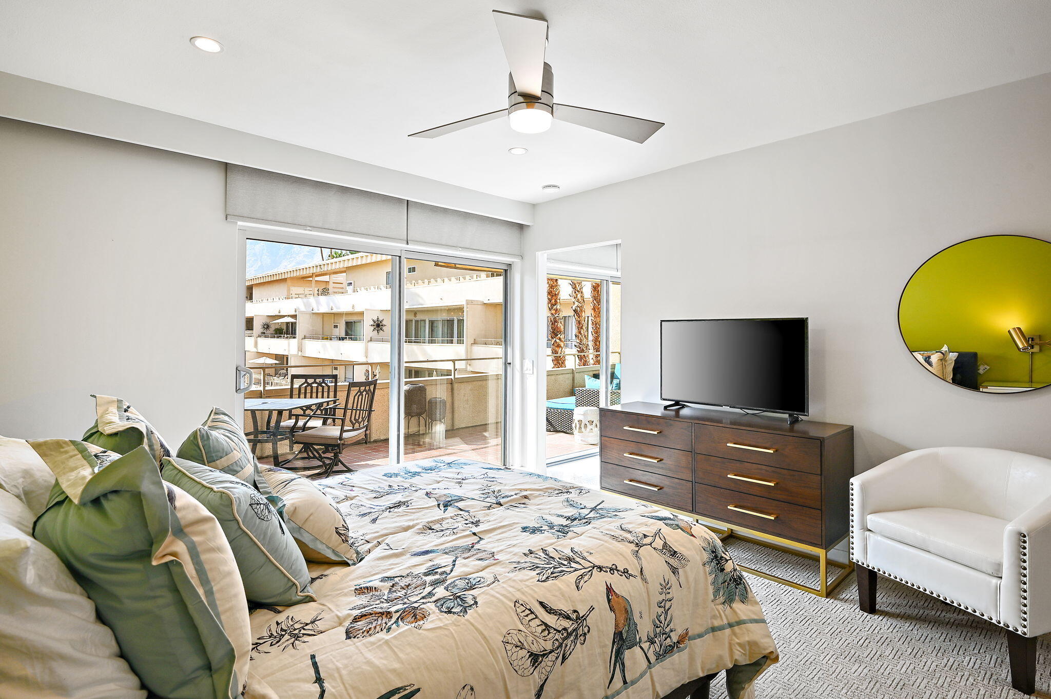 277 East Alejo Road, Unit 215 Palm Springs, CA 92262 - Photo 31 of 52 a bedroom with a bed and a flat screen tv