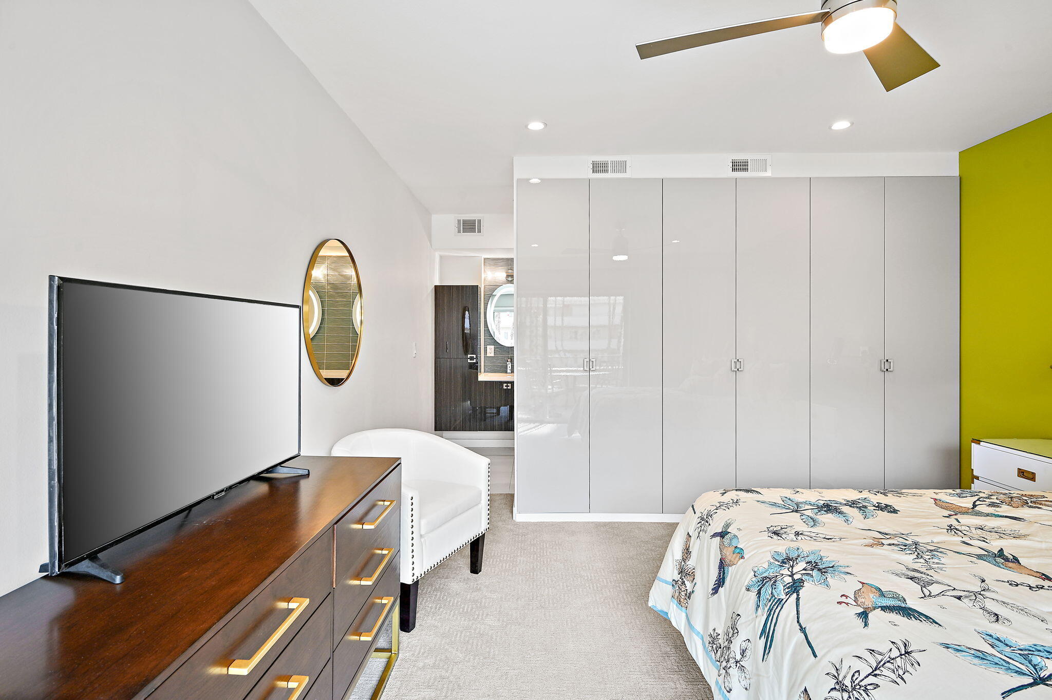 277 East Alejo Road, Unit 215 Palm Springs, CA 92262 - Photo 32 of 52 a bedroom with a bed and chandelier