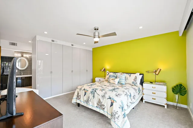 a bedroom with a bed and a television