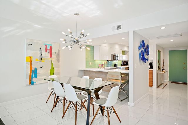 a view of a dining room with furniture and a kitchen