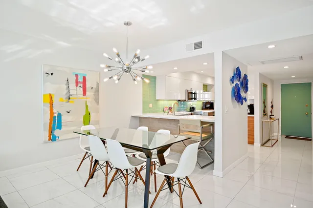 a view of a dining room with furniture and a kitchen