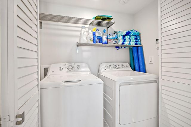 a bedroom with a bed a table and chair