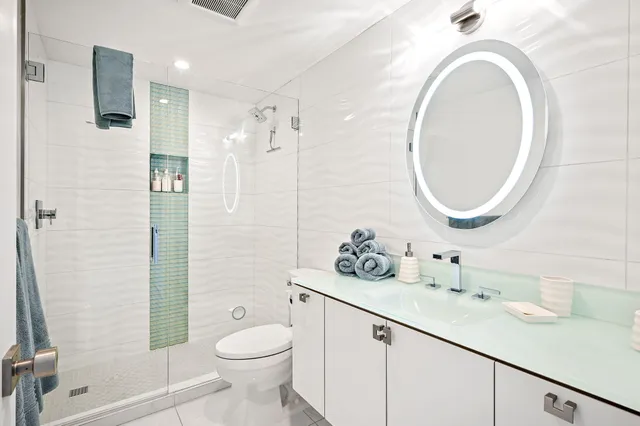 a bathroom with a sink toilet and shower