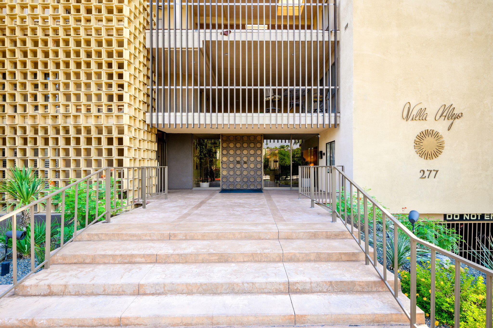 277 East Alejo Road, Unit 215 Palm Springs, CA 92262 - Photo 49 of 52 a front view of a house with a garden