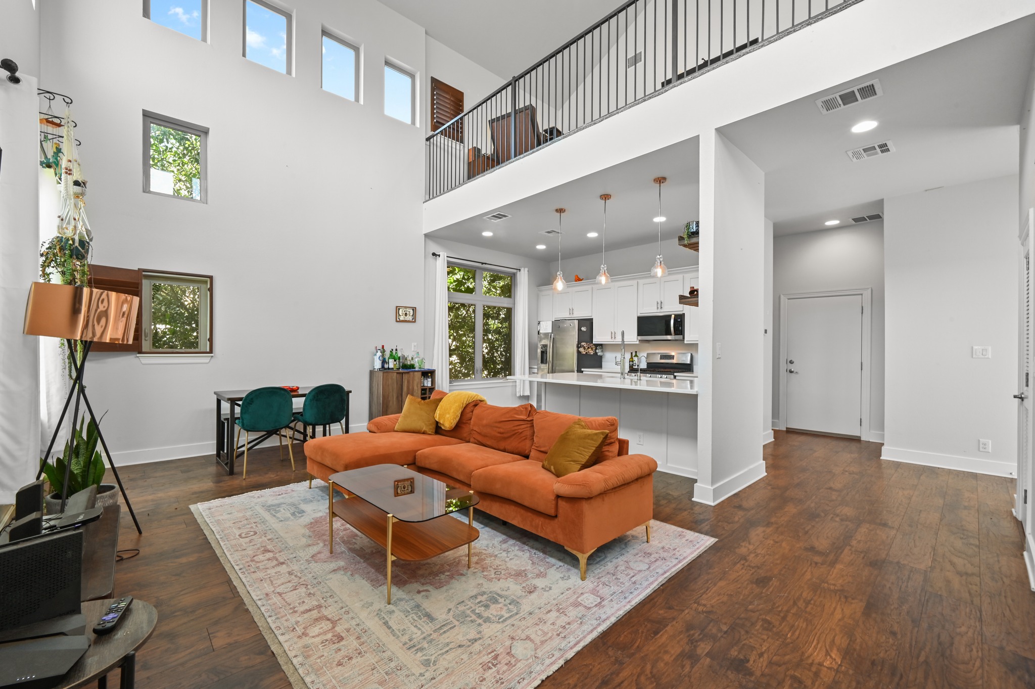592 Farm To Market 967, Unit B Buda, TX 78610 - Photo 11 of 26 The soaring ceilings and open sightlines create a truly spacious feel, while the versatile upstairs loft overlooks the main living area—perfect for a home office, media space, or cozy retreat.