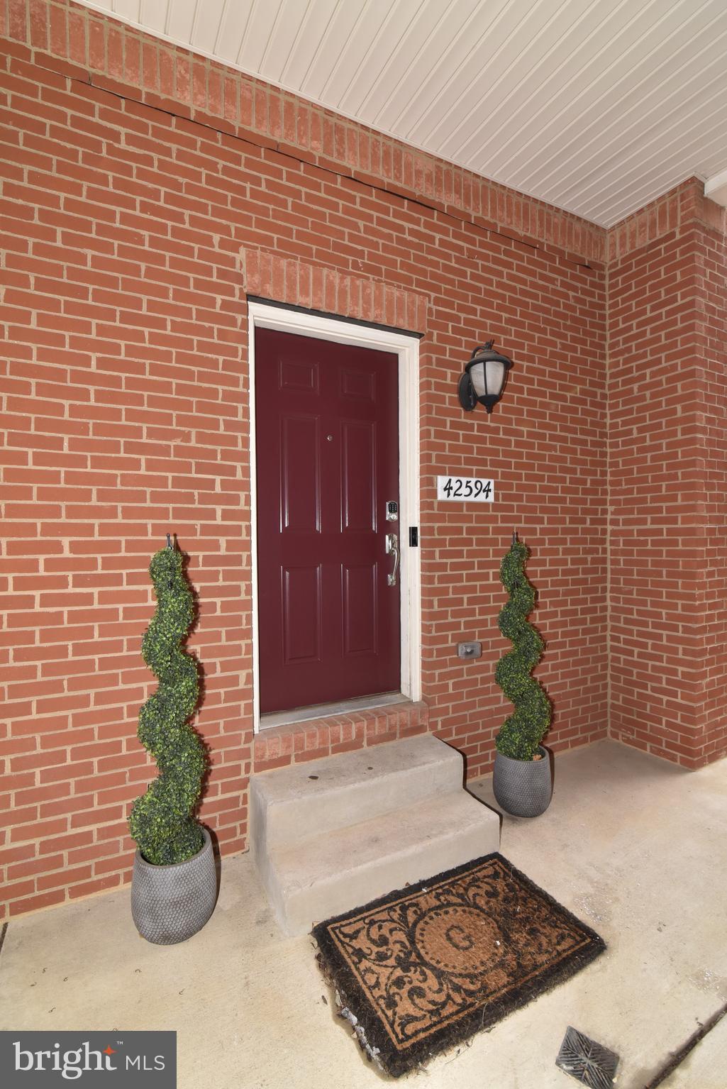 42594 Sunset Ridge Square, Unit 42594 Ashburn, VA 20148 - Photo 33 of 41 Great covered entryway allows protection for all
