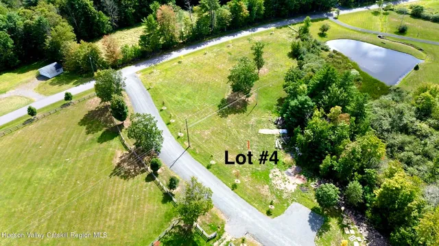an aerial view of a residential houses with yard