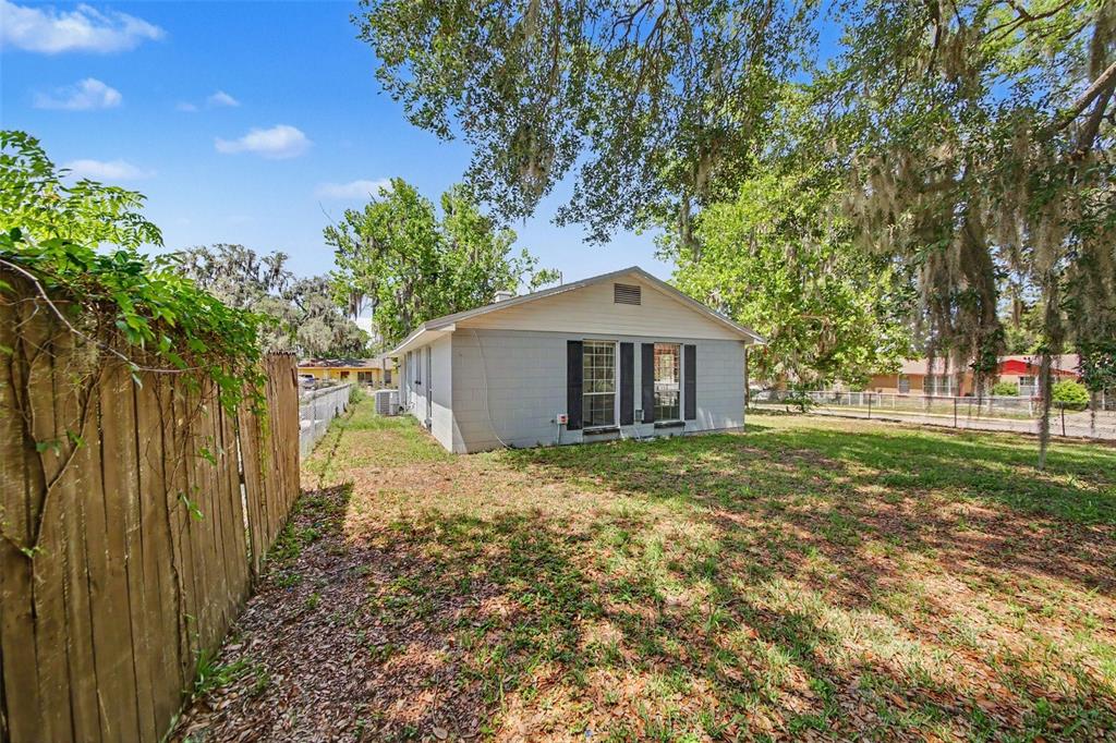 1109 Inland Street Leesburg, FL 34748 - Photo 15 of 15 a house with trees in front of it