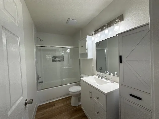 a bathroom with a double vanity sink toilet and shower