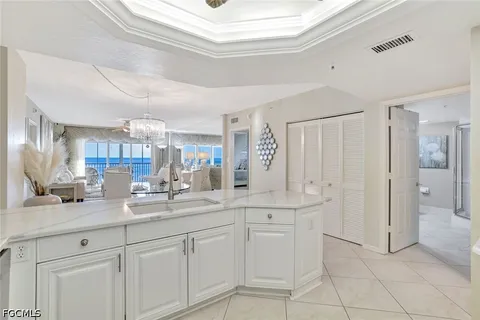 a kitchen with stainless steel appliances kitchen island granite countertop a refrigerator a oven a sink and a refrigerator