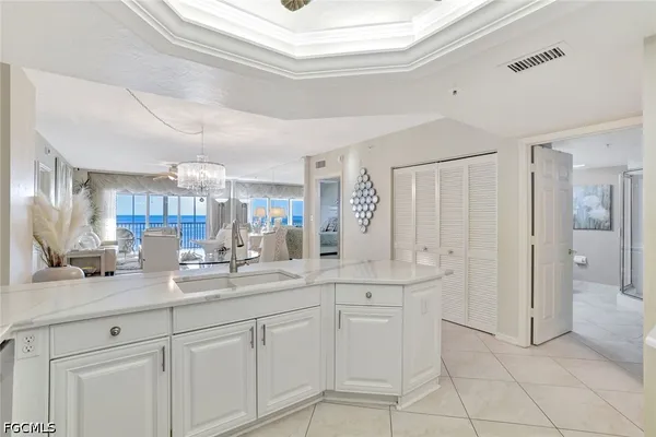 a kitchen with stainless steel appliances kitchen island granite countertop a refrigerator a oven a sink and a refrigerator