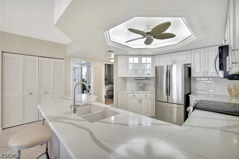 a kitchen with stainless steel appliances a sink and a refrigerator