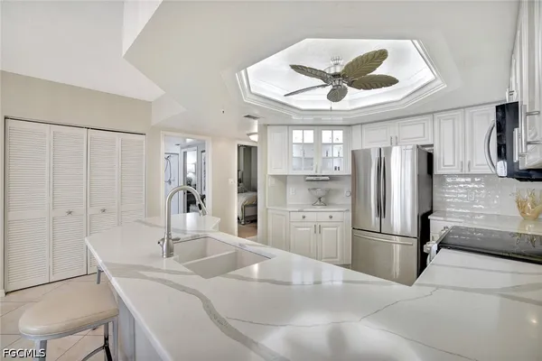 a kitchen with stainless steel appliances a sink and a refrigerator