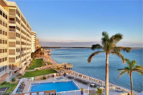 a view of a living room and balcony with furniture