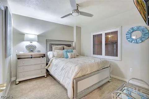 a living room with furniture a large window and a flat screen tv