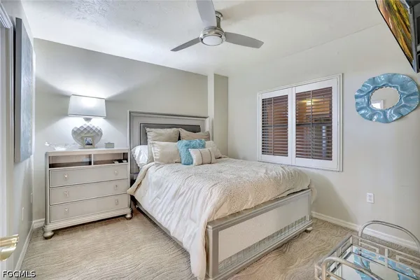 a living room with furniture a large window and a flat screen tv