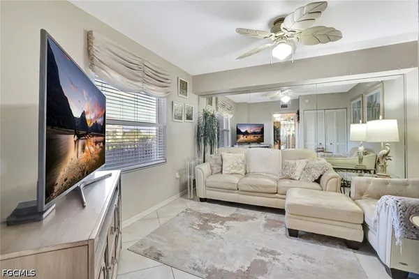a living room with furniture and floor to ceiling windows