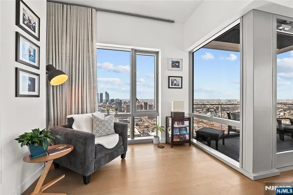a living room with furniture and a floor to ceiling window