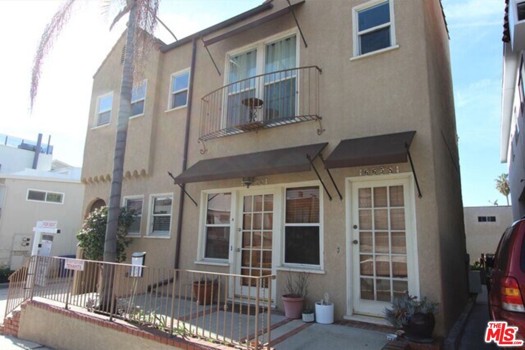 6656 Vista Del Mar, Unit A Playa del Rey, CA 90293 - Photo 1 of 16 a view of a brick building next to a yard