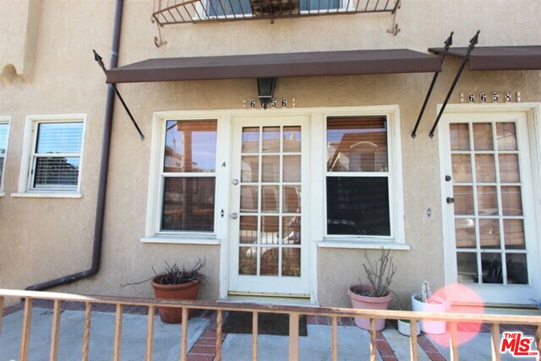 6656 Vista Del Mar, Unit A Playa del Rey, CA 90293 - Photo 2 of 16 a front view of a building with glass windows