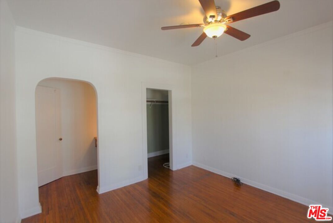 6656 Vista Del Mar, Unit A Playa del Rey, CA 90293 - Photo 4 of 16 an empty room with wooden floor closet and fan