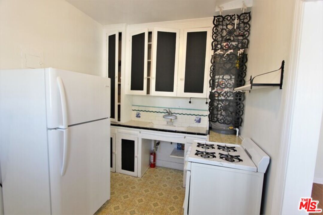 6656 Vista Del Mar, Unit A Playa del Rey, CA 90293 - Photo 10 of 16 a kitchen with a white stove top oven and sink