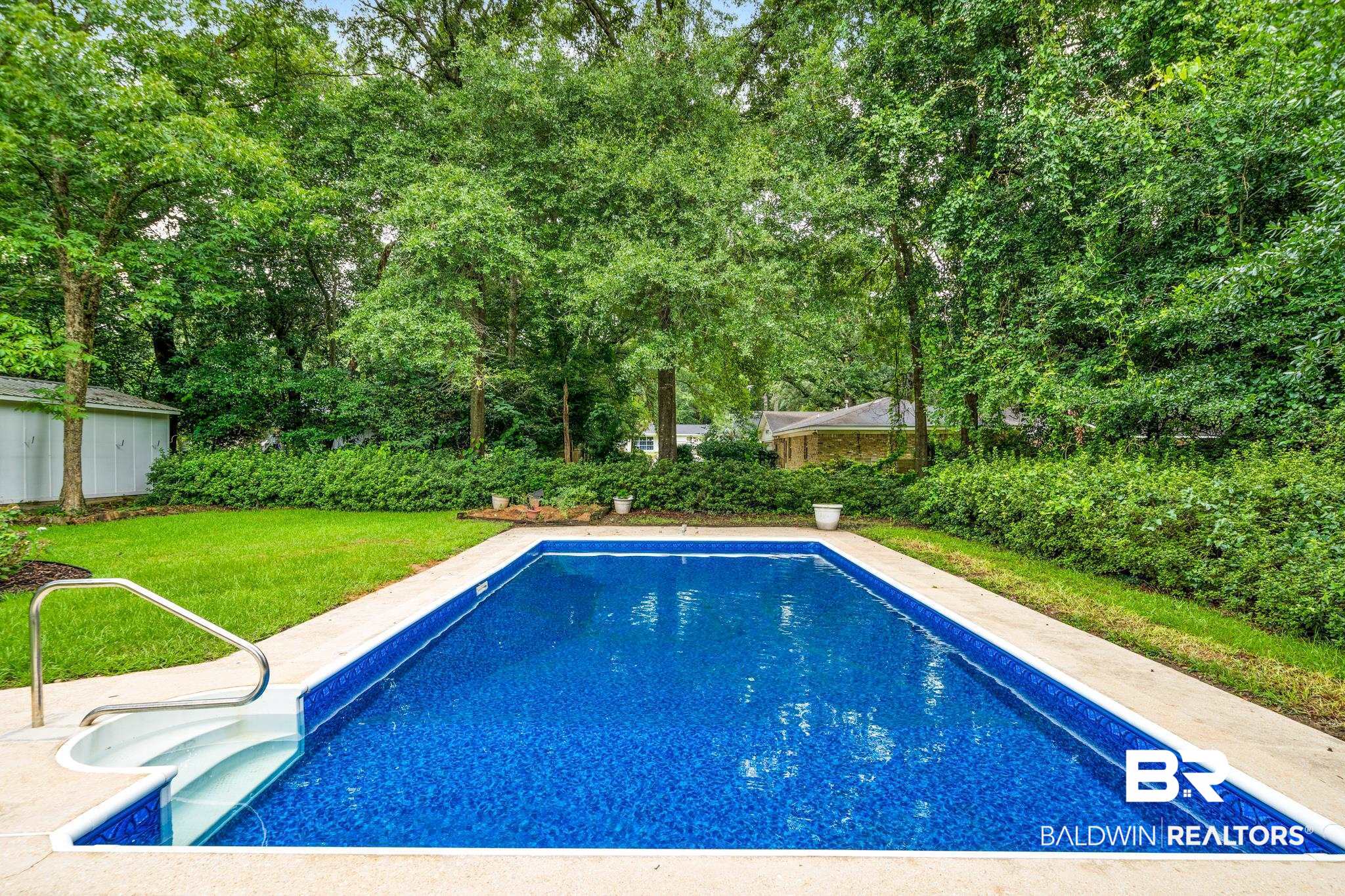 280 Thrift Street Mobile, AL 36609 - Photo 17 of 22 View of swimming pool featuring a lawn