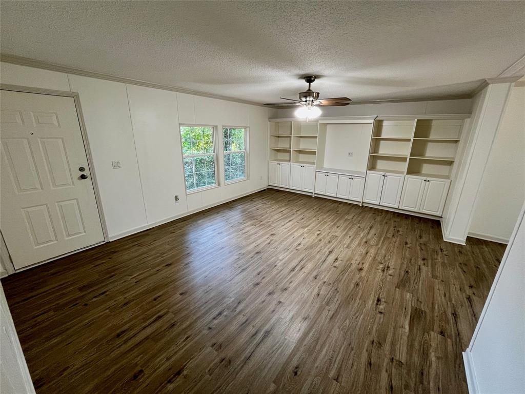 6913 Rice Road Shreveport, LA 71129 - Photo 11 of 26 wooden floor in an empty room with a window