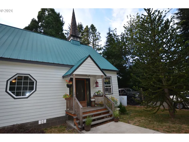a view of house with backyard and outdoor seating