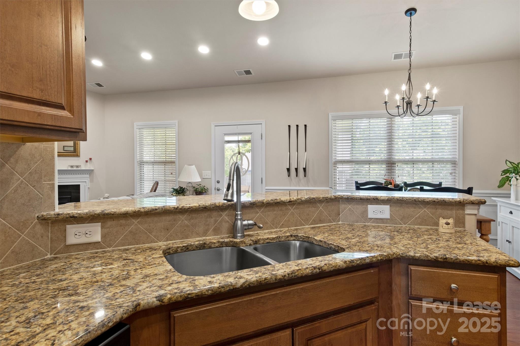 7266 Kenyon Drive Denver, NC 28037 - Photo 12 of 25 a kitchen with stainless steel appliances granite countertop a sink a counter space a stove and a window