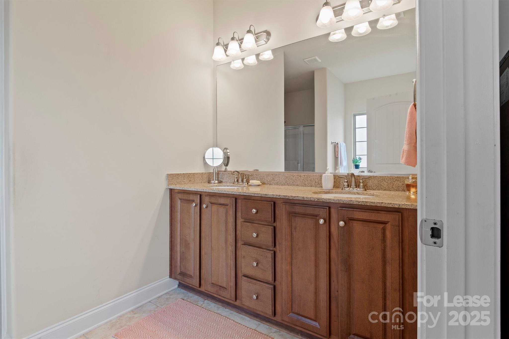 7266 Kenyon Drive Denver, NC 28037 - Photo 17 of 25 a bathroom with a double vanity and a mirror