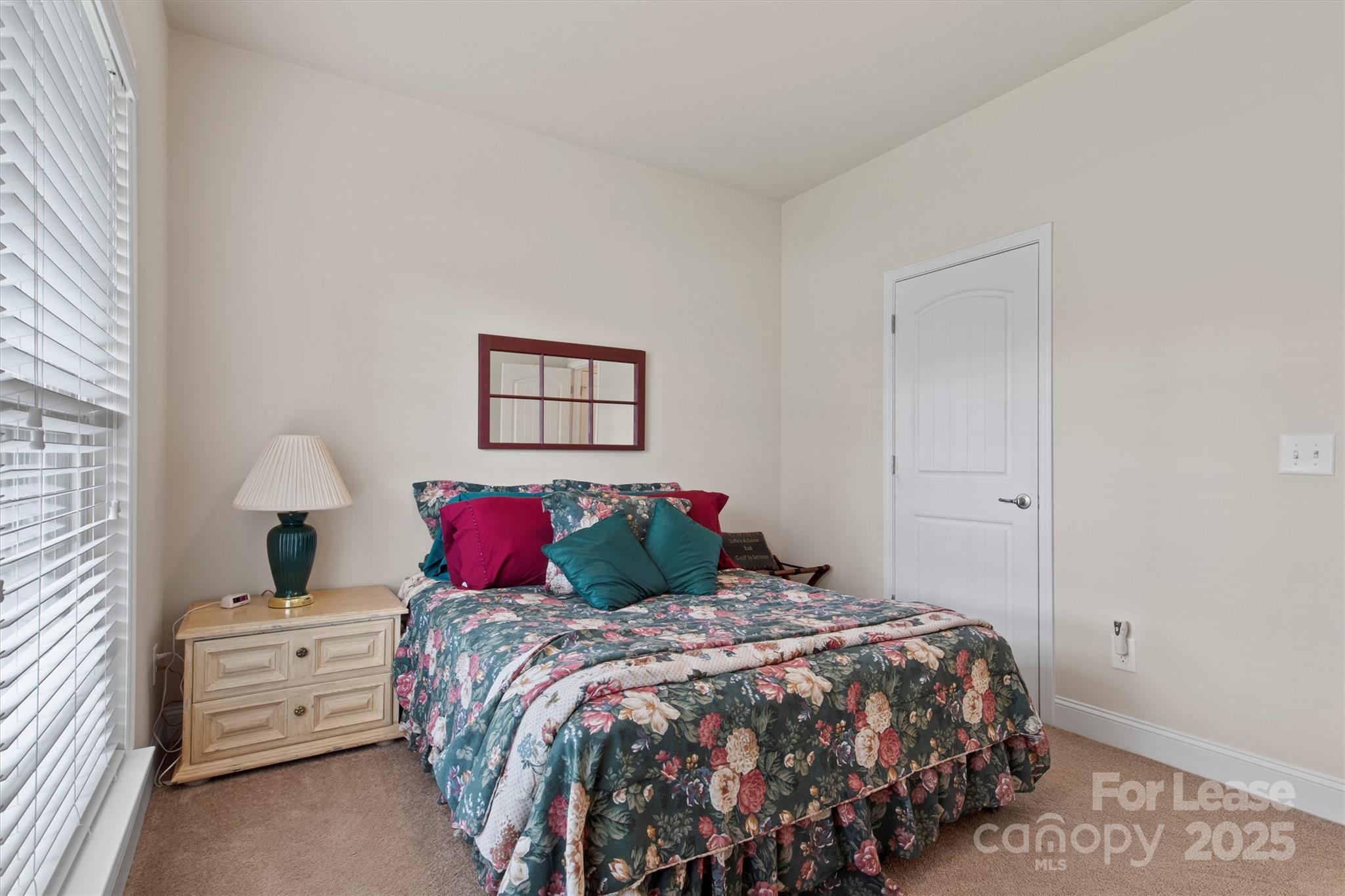 7266 Kenyon Drive Denver, NC 28037 - Photo 18 of 25 a bedroom with a bed and a night stand