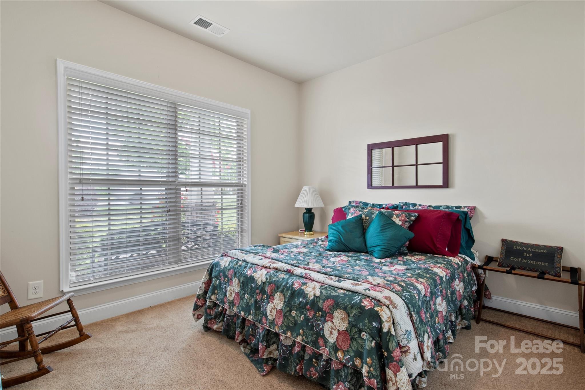 7266 Kenyon Drive Denver, NC 28037 - Photo 19 of 25 a bedroom with a large bed and two windows