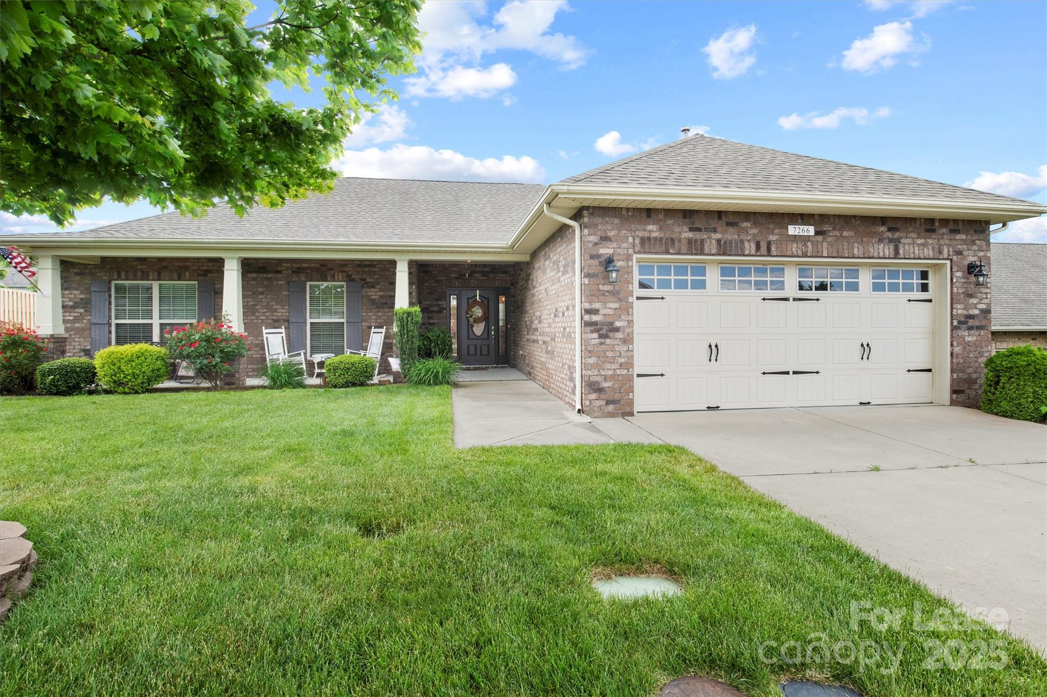 7266 Kenyon Drive Denver, NC 28037 - Photo 2 of 25 a front view of a house with garden