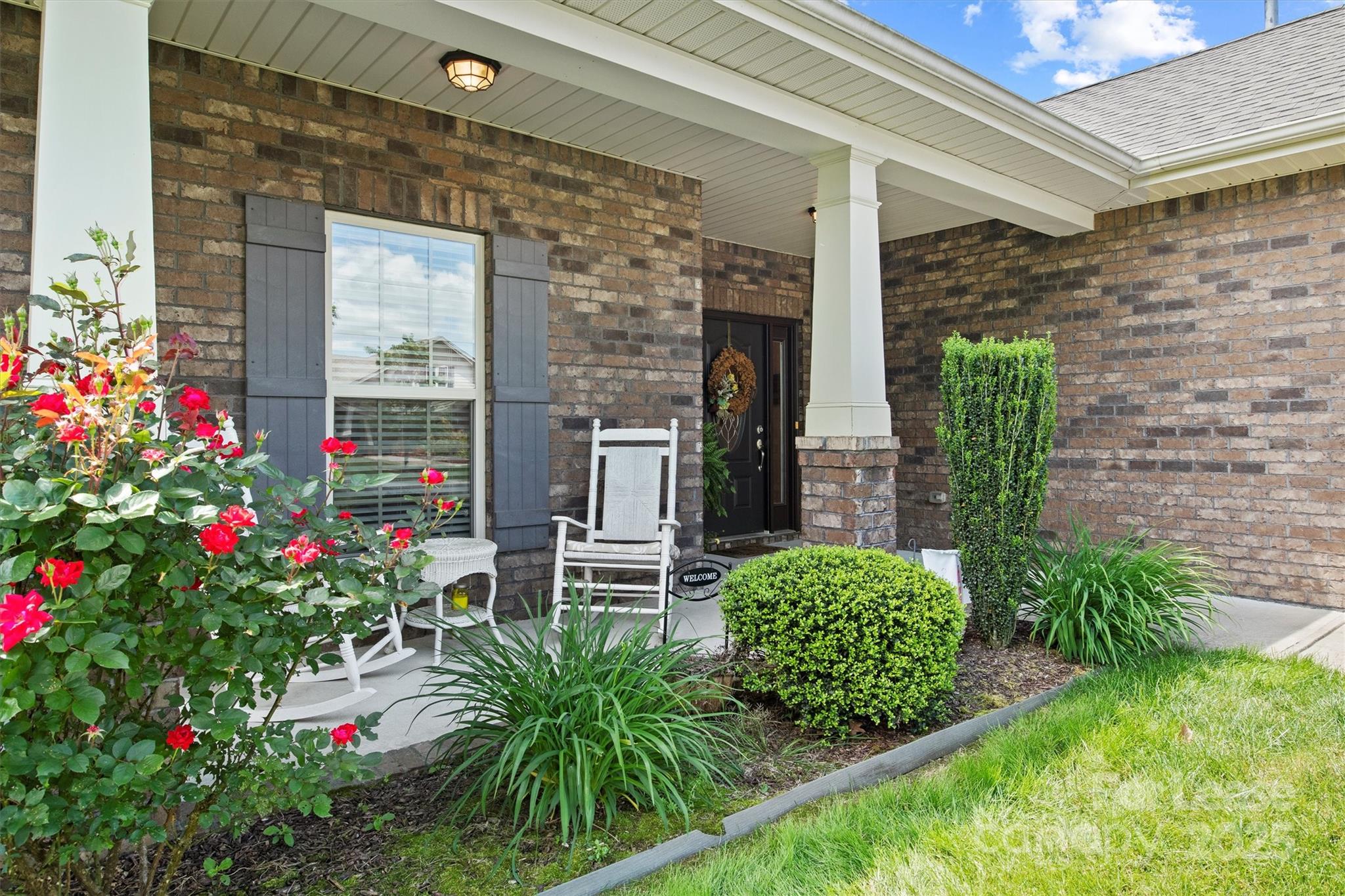 7266 Kenyon Drive Denver, NC 28037 - Photo 5 of 25 a flower plants in front of a door