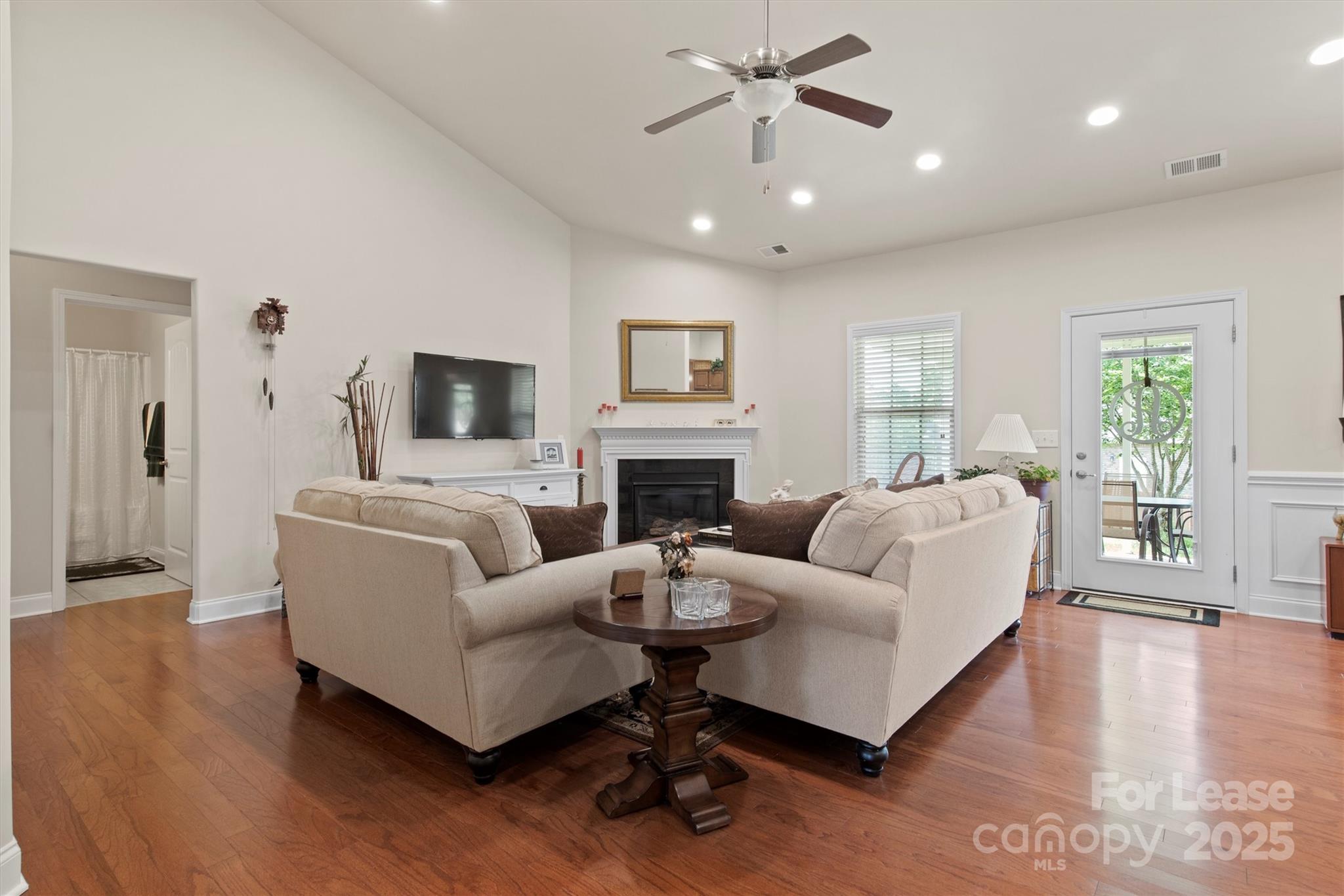 7266 Kenyon Drive Denver, NC 28037 - Photo 6 of 25 a living room with fireplace furniture and a wooden floor