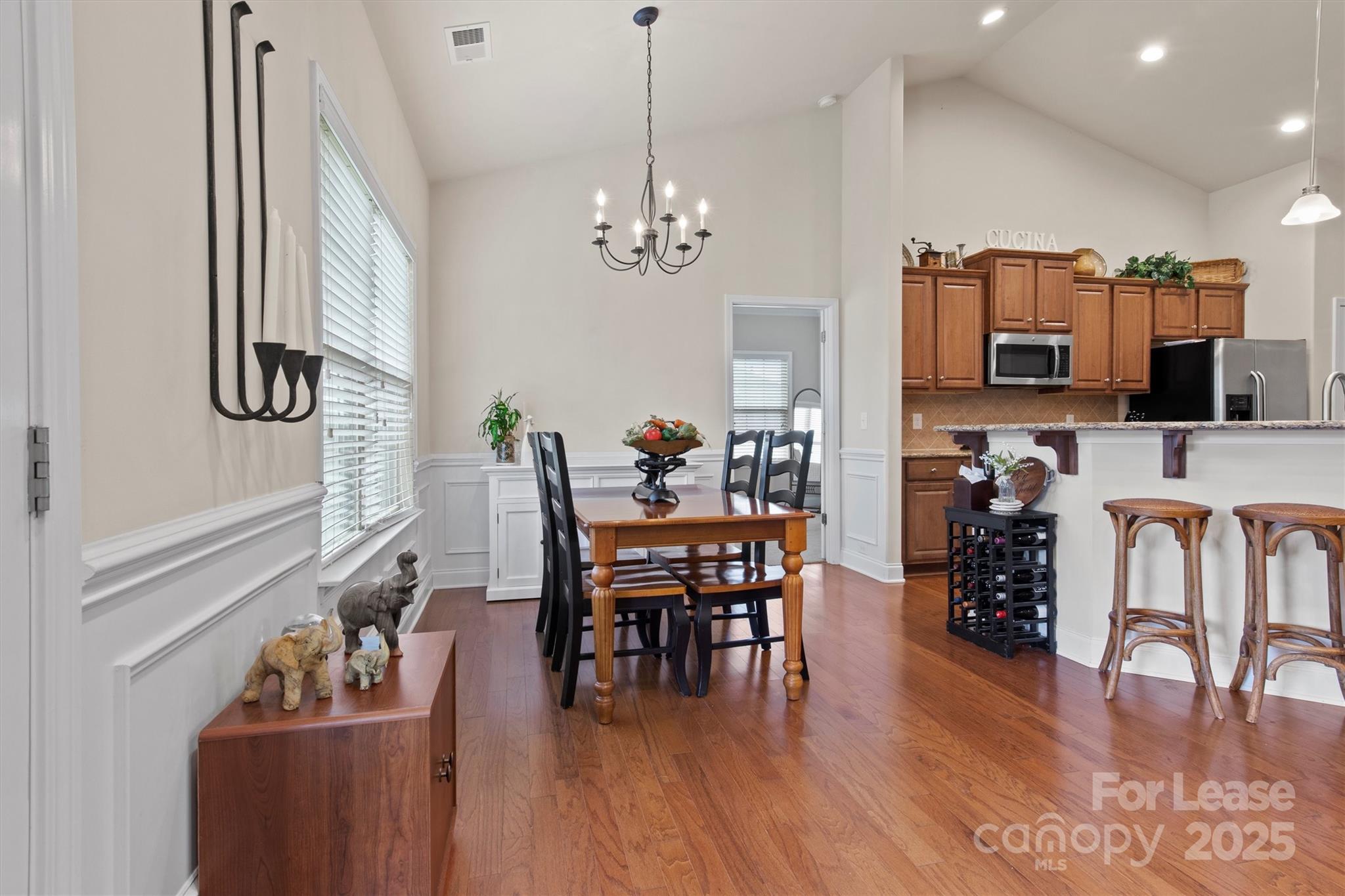 7266 Kenyon Drive Denver, NC 28037 - Photo 8 of 25 a dining room with furniture entryway and wooden floor