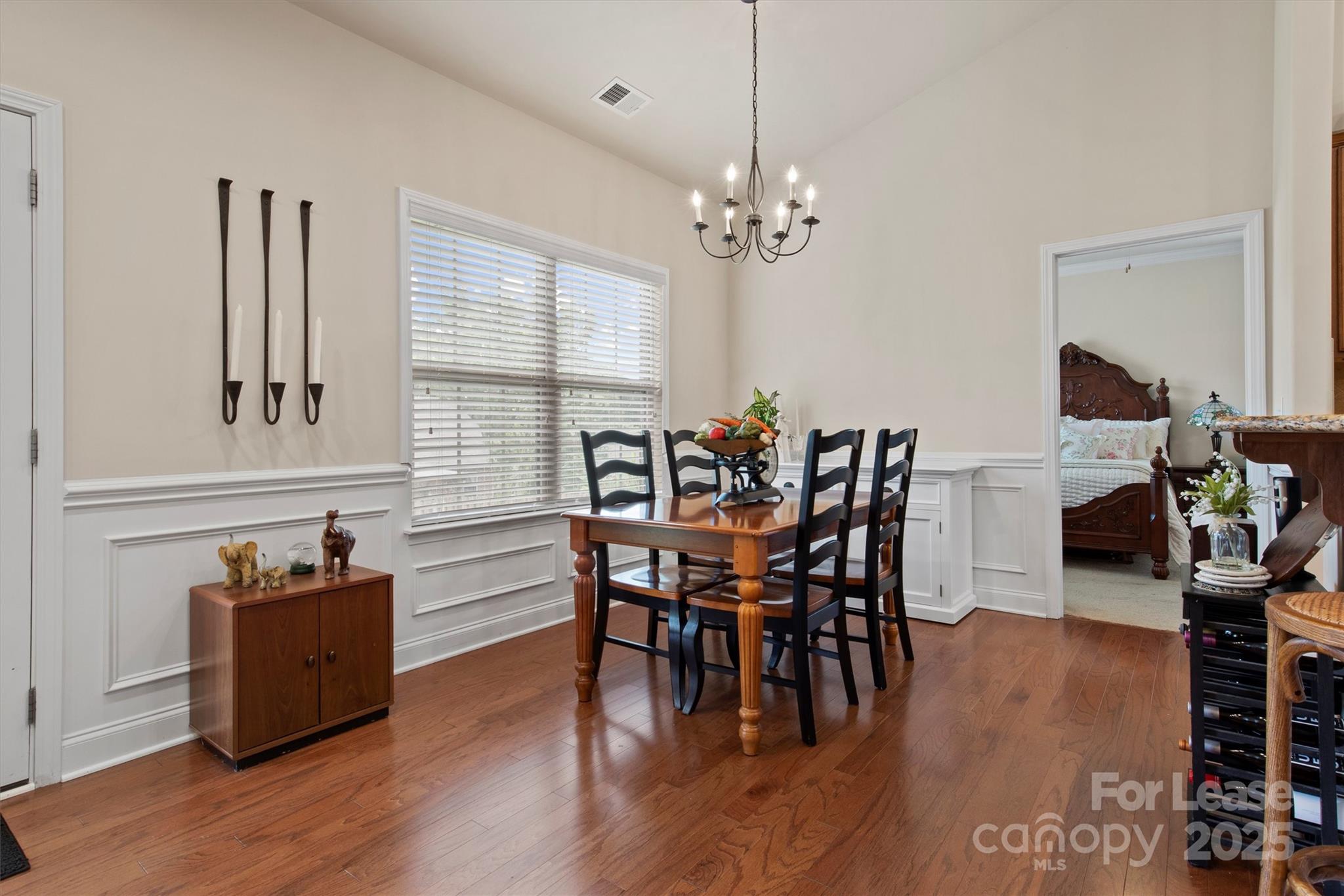 7266 Kenyon Drive Denver, NC 28037 - Photo 9 of 25 a view of a dining room with furniture window and wooden floor