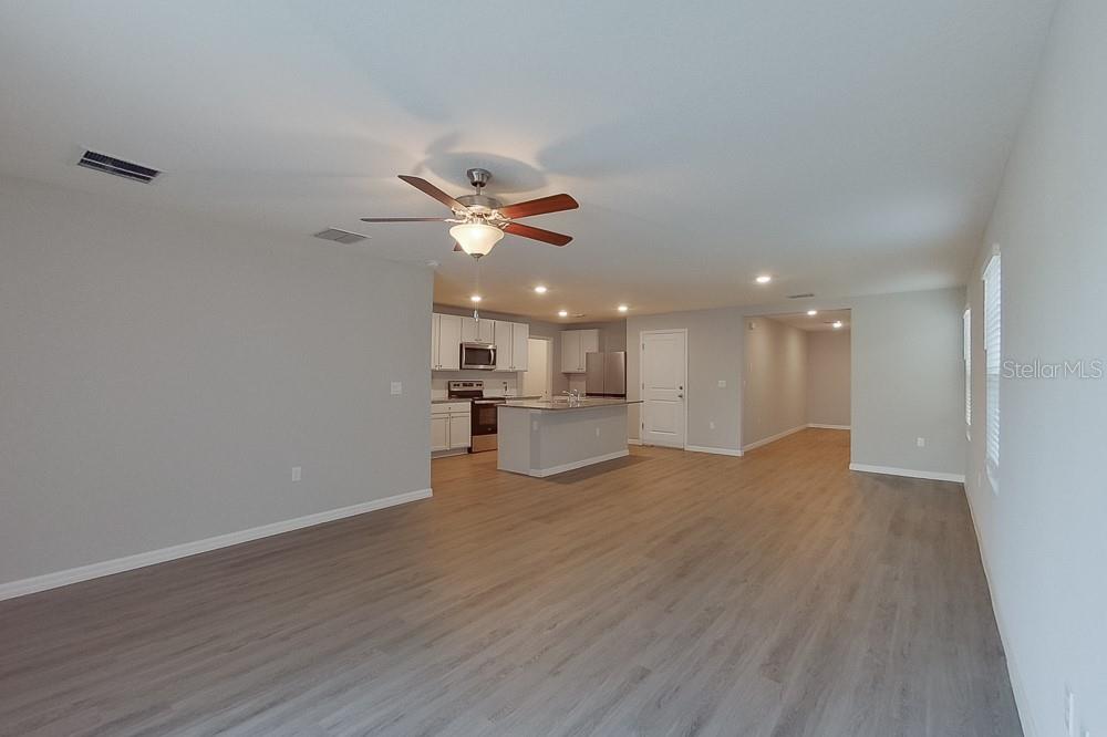 4397 Southwest 85th Lane Ocala, FL 34476 - Photo 8 of 23 a view of an empty room with wooden floor and a window