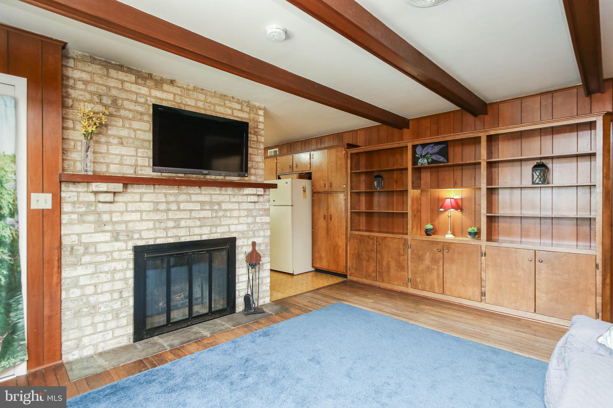 5004 Old Quarter Road Upperco, MD 21155 - Photo 20 of 61 a living room with a fireplace and a flat screen tv