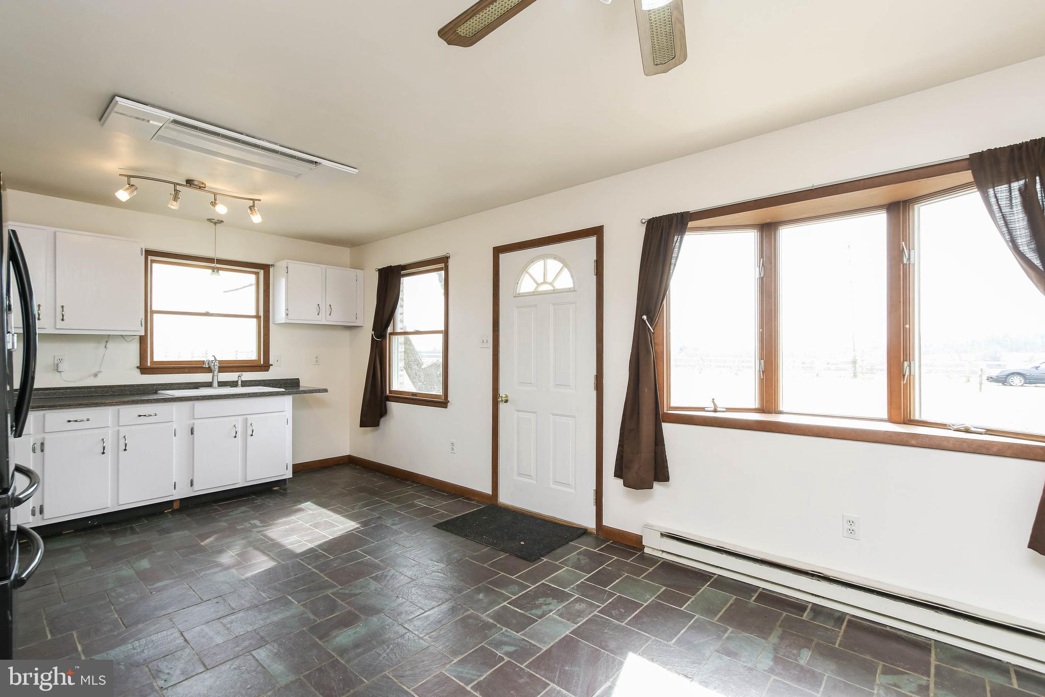 5004 Old Quarter Road Upperco, MD 21155 - Photo 36 of 61 The area has a bay window and slate flooring.