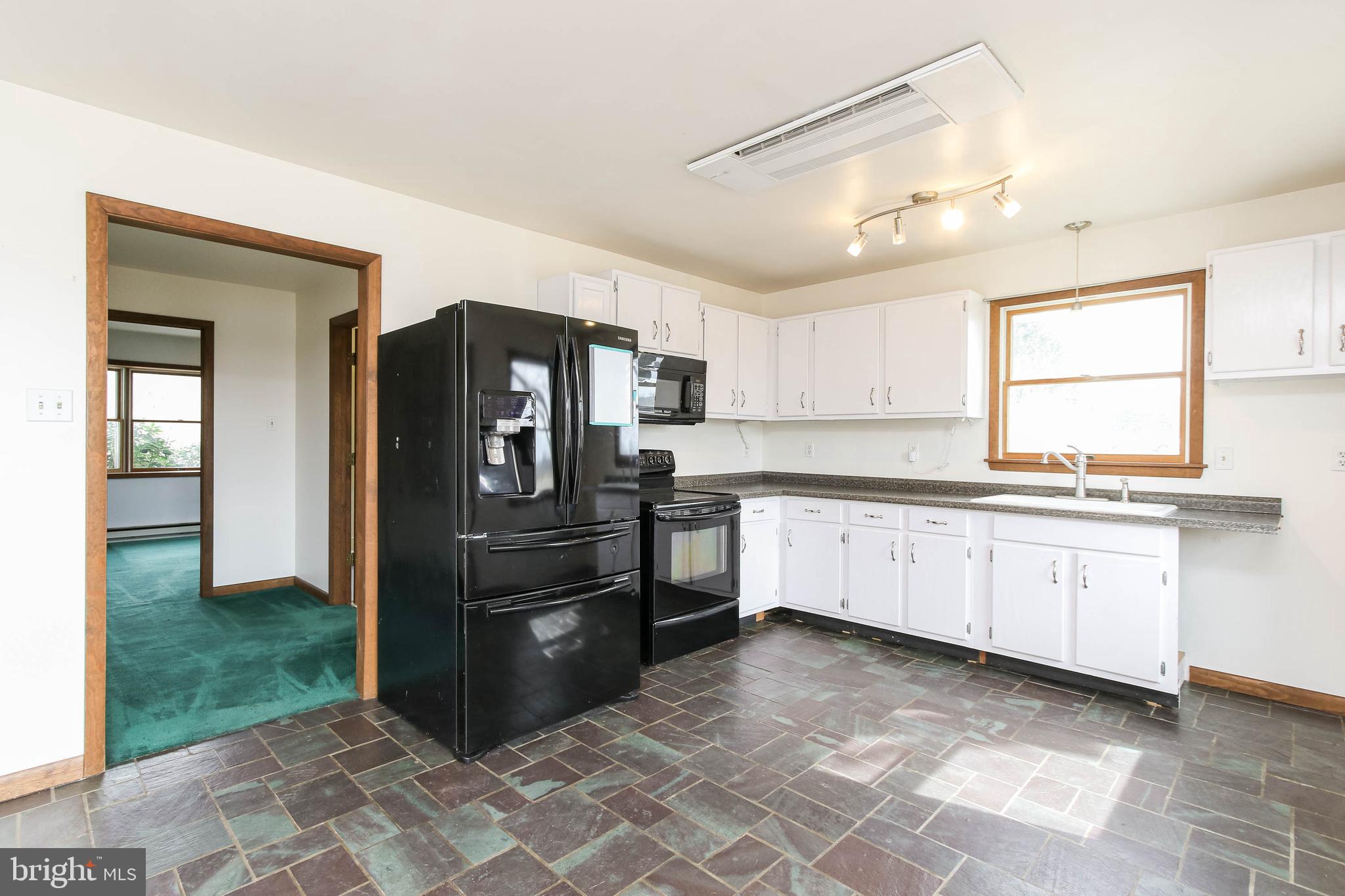 5004 Old Quarter Road Upperco, MD 21155 - Photo 38 of 61 a kitchen with granite countertop a refrigerator and a stove top oven
