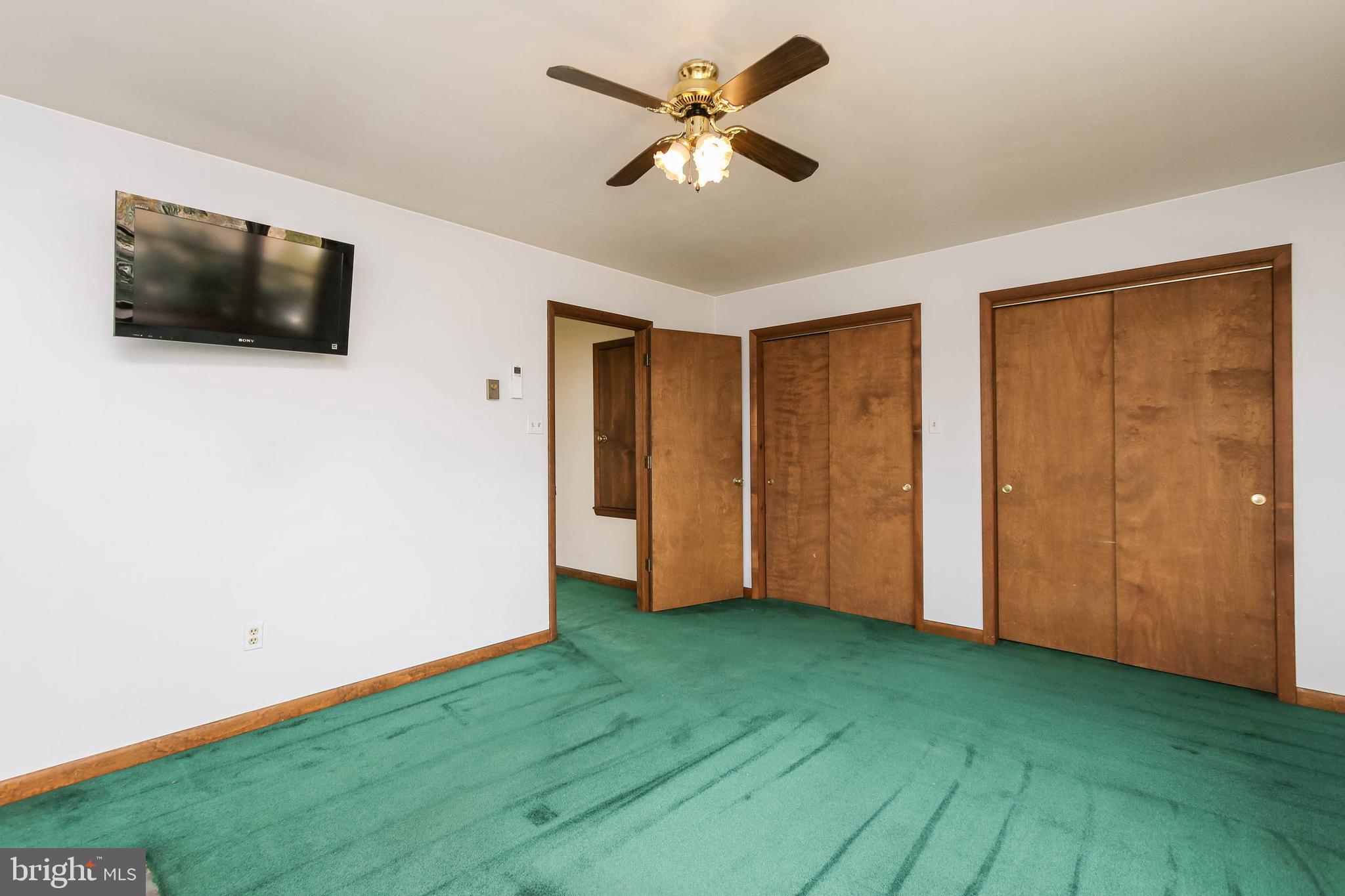5004 Old Quarter Road Upperco, MD 21155 - Photo 40 of 61 a view of an empty room with wooden floor and a ceiling fan