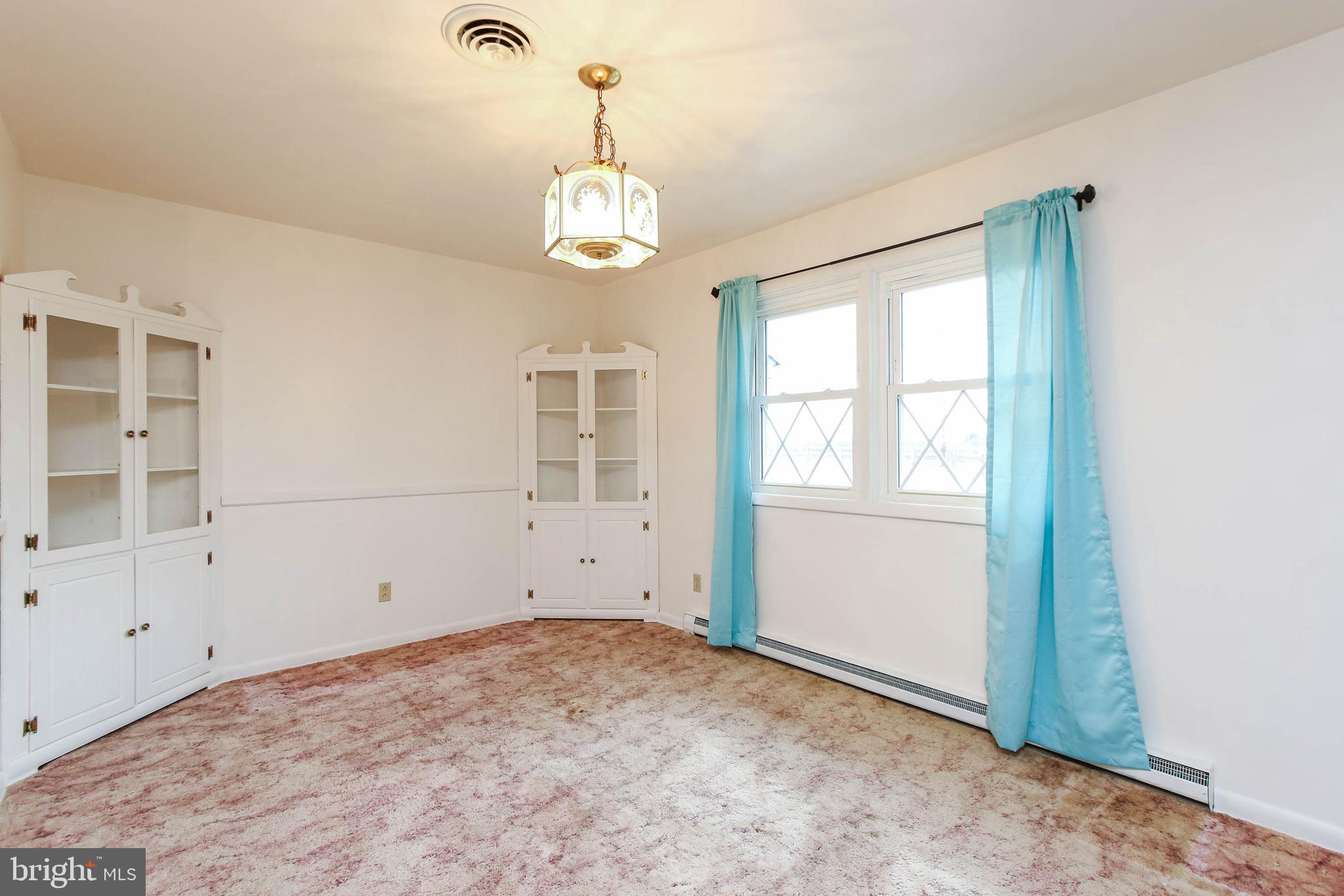 5004 Old Quarter Road Upperco, MD 21155 - Photo 10 of 61 an empty room with chandelier fan and windows