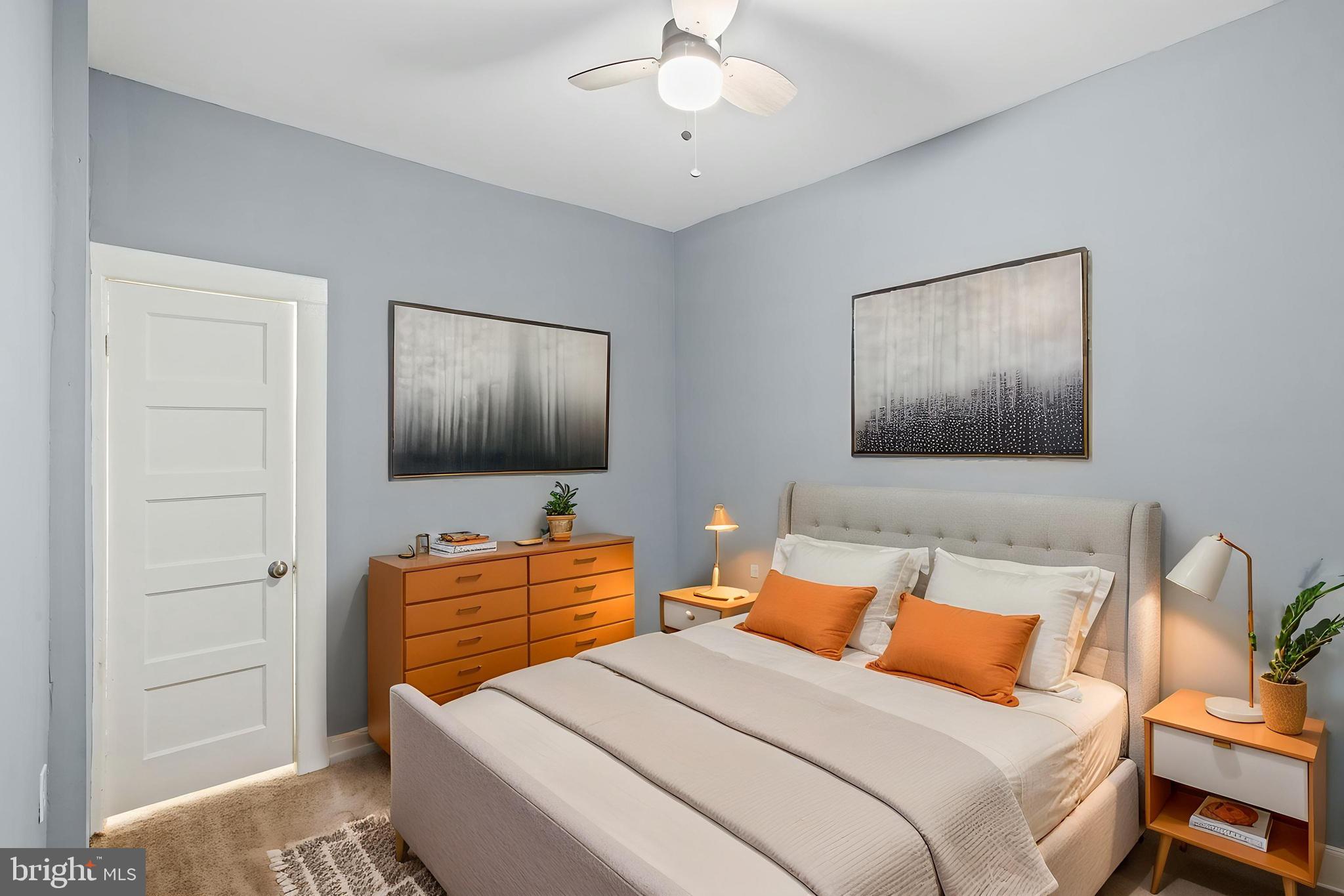 2811 Erdman Avenue Baltimore, MD 21213 - Photo 12 of 17 a bedroom with a bed and a flat screen tv