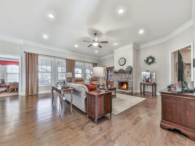 a kitchen with stainless steel appliances granite countertop a stove a refrigerator a oven a kitchen island with a dining table and chairs