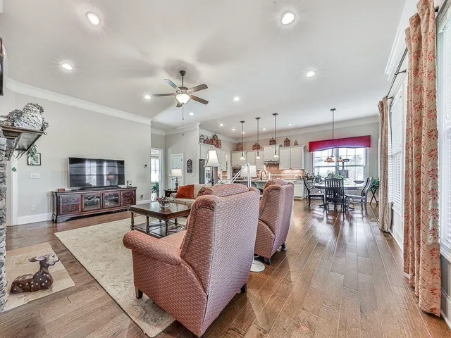 a kitchen with stainless steel appliances granite countertop a refrigerator a stove and a sink