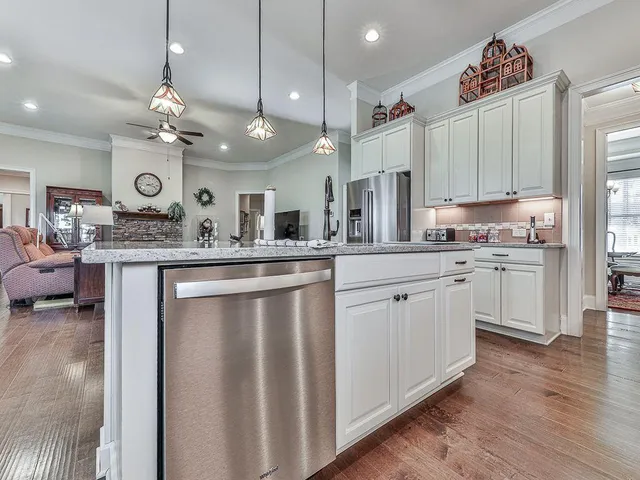 a bedroom with furniture and a large window