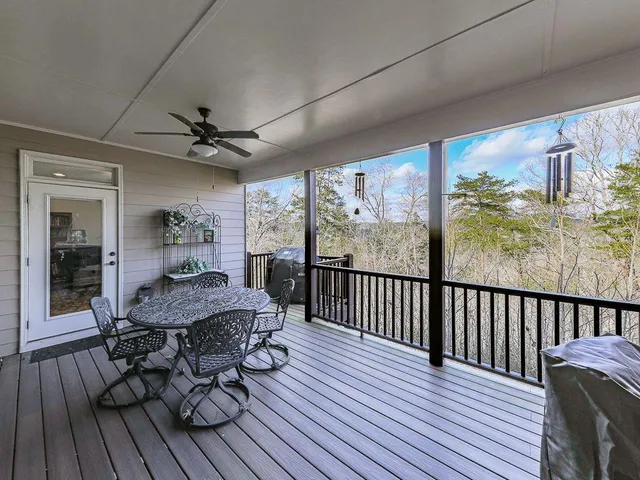 a view of a dining room with furniture a chandelier and wooden floor